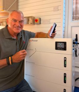 Matt Stockdale with installed system that reduces energy bills